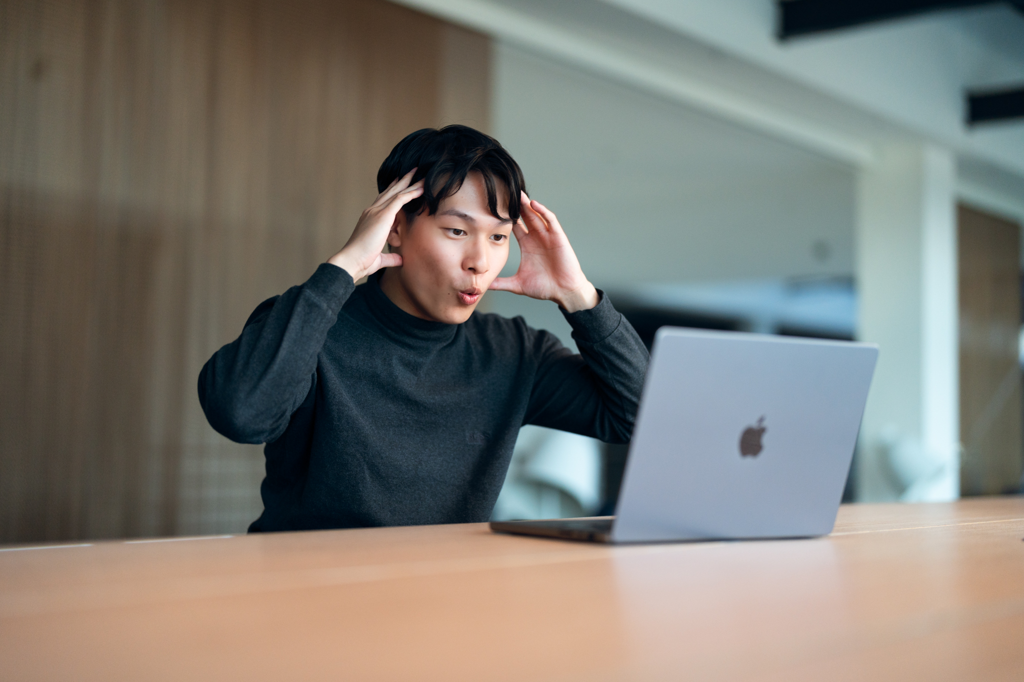 CTO and Founder Jackson Ly sitting in a lounge working on a MacBook
